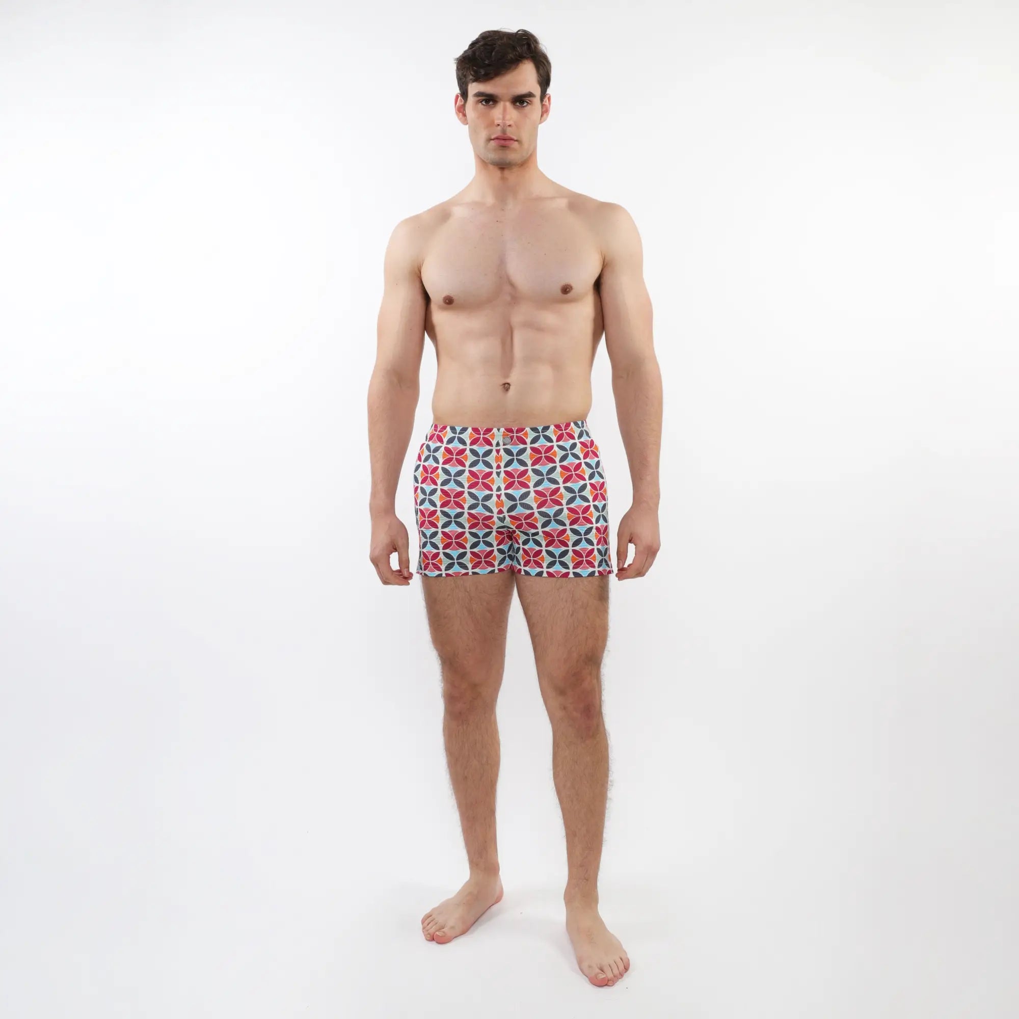 Seersucker swim shorts with mesh lining featuring vibrant red blue and white geometric patterned men’s swim trunks