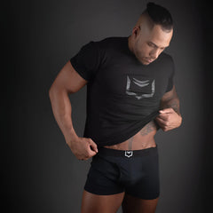 Black athletic t-shirt with a silver geometric logo on the chest featured in sheath 2.1 dual pouch trunks 3 pack bundle
