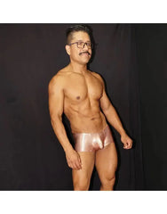 Shiny copper men's boxer underwear by Arroyman featuring a snug fit and smooth material modeled by a man.