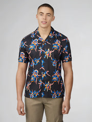 Black short-sleeved button-up shirt with vibrant blue pink and orange orchid floral pattern signature botanical print