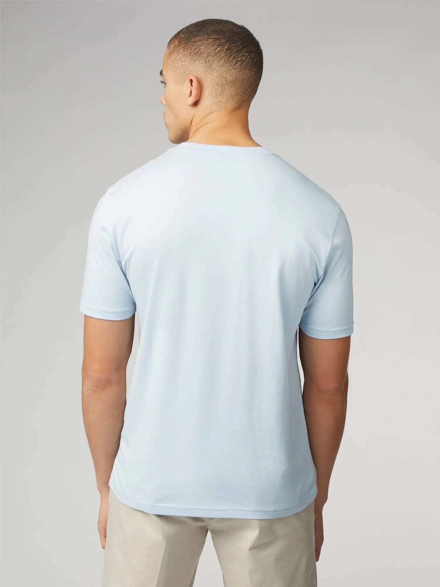 A light blue signature t-shirt with chest pocket made of soft cotton fabric featuring short sleeves and crew neck