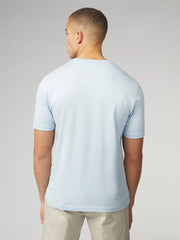 A light blue signature t-shirt with chest pocket made of soft cotton fabric featuring short sleeves and crew neck