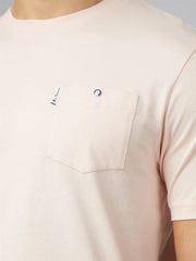 A soft blush pink signature t shirt with chest pocket featuring silver button closure and branded tag on upper left corner