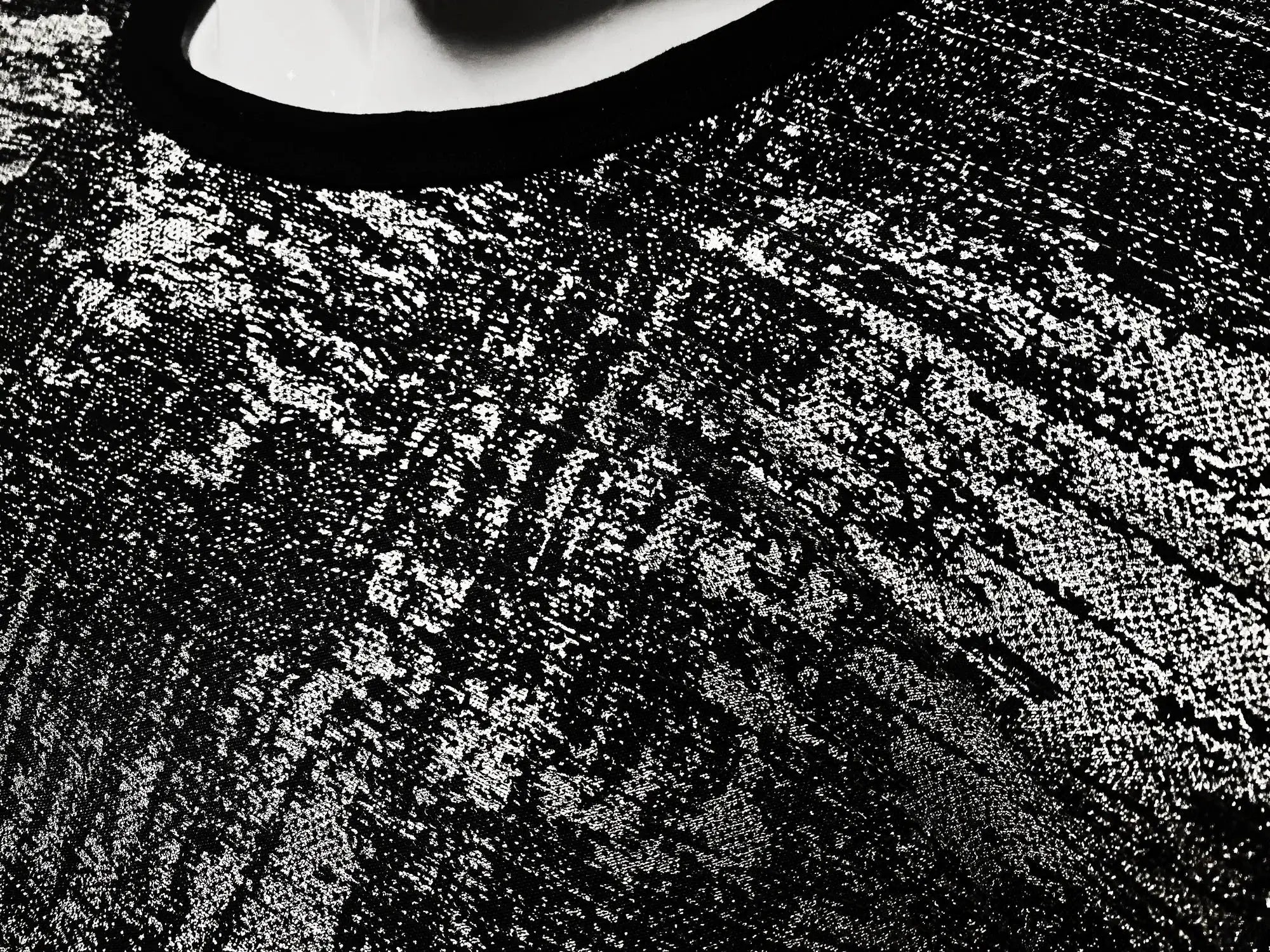 Black lace silver leaf tee with intricate textured pattern showcasing elegant sheer design