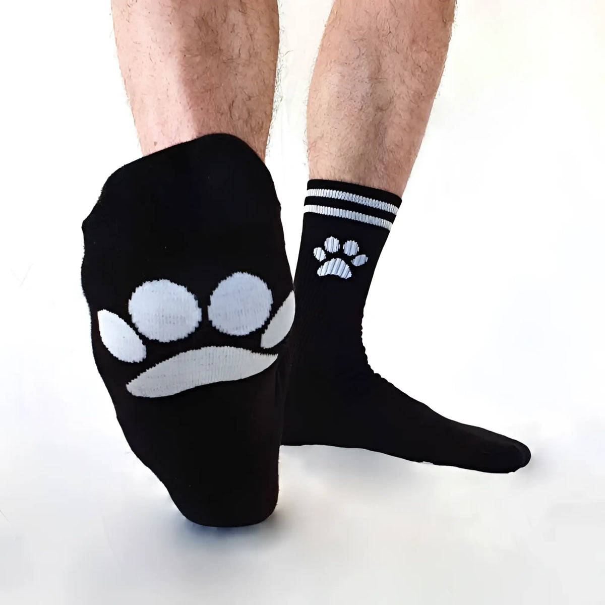 Black Sk8erboy puppy socks size 39-42 with white paw prints featuring larger and smaller designs on foot and ankle