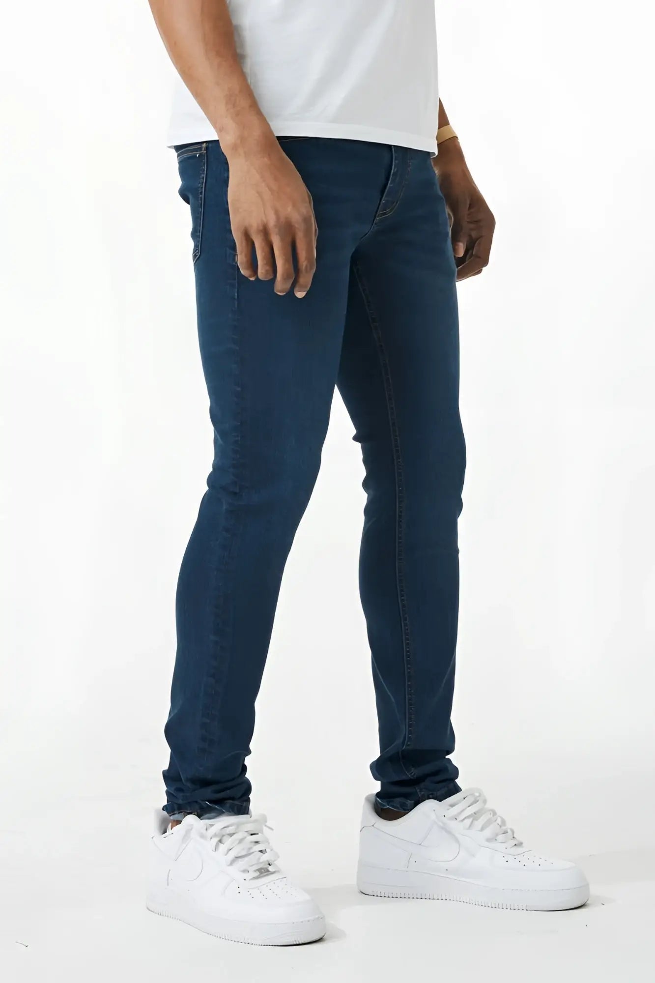 Dark blue skinny fit denim jeans with slim fit, classic five-pocket design, and subtle fading along the thighs