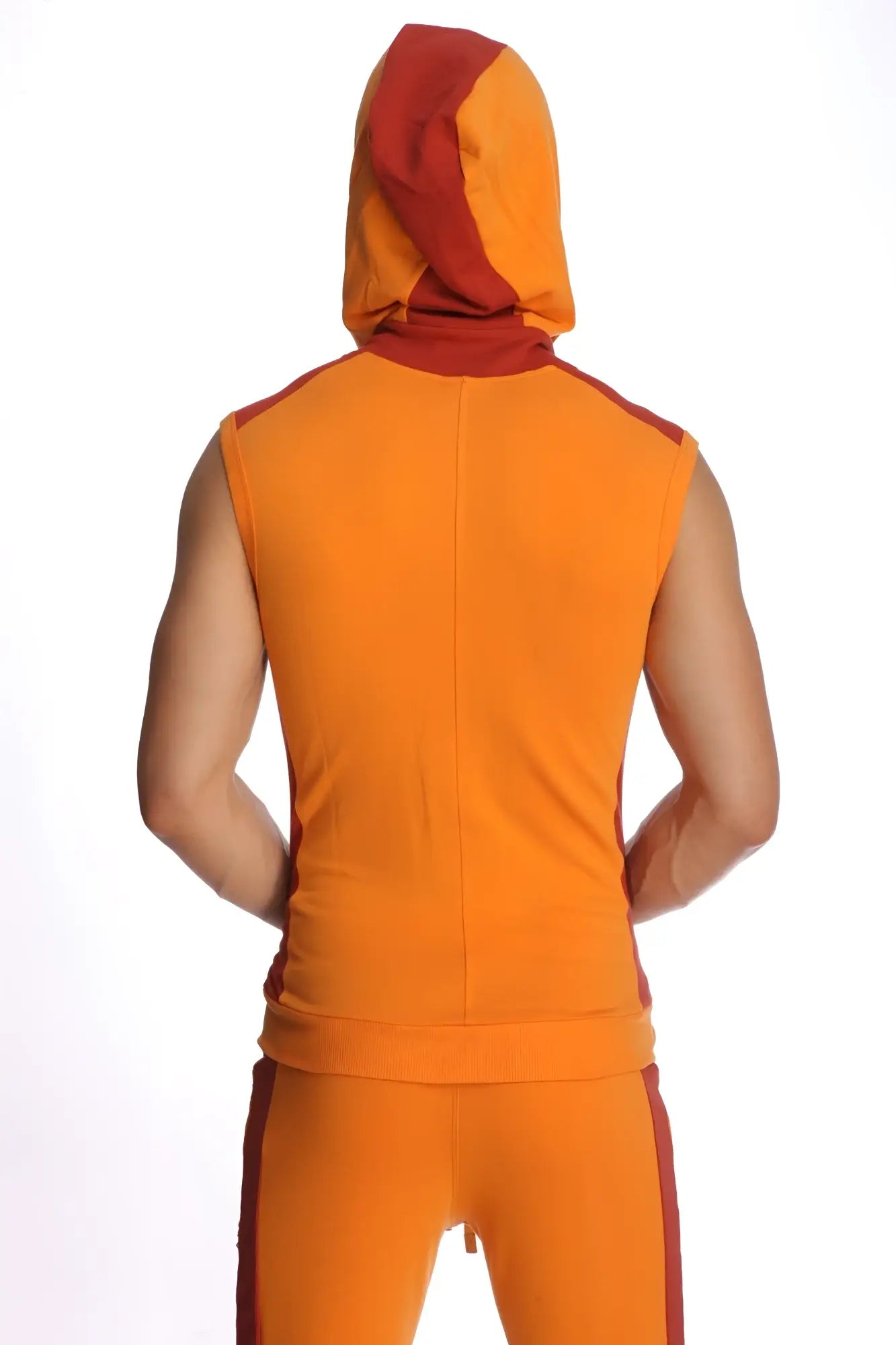 Orange and red sleeveless yoga hoodie with snug fit and matching pants featuring bold color contrast