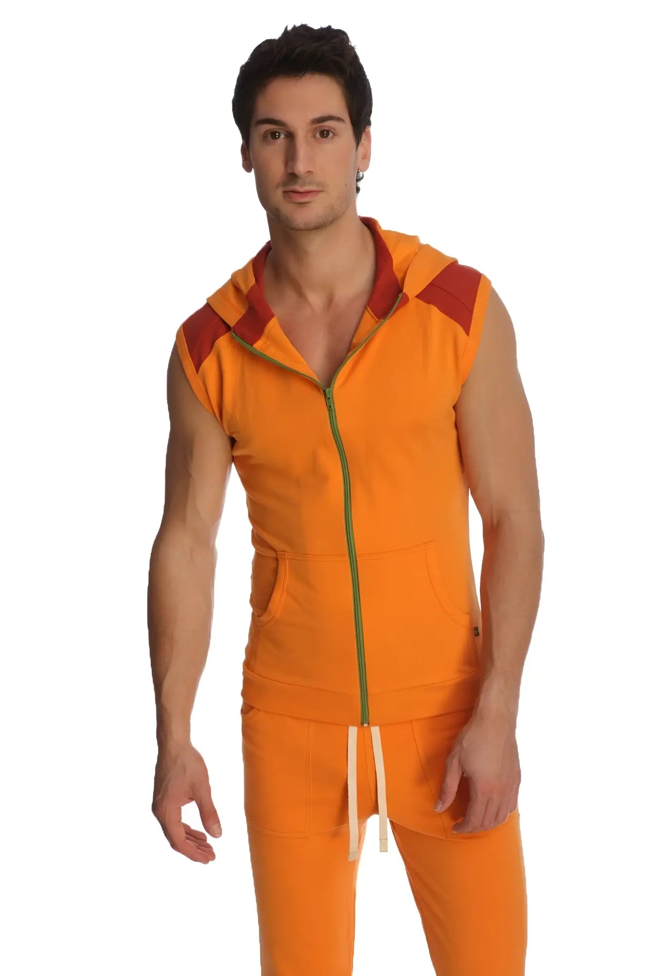 Orange sleeveless yoga hoodie with red shoulder panels and green zipper trim designed for comfort and flexibility