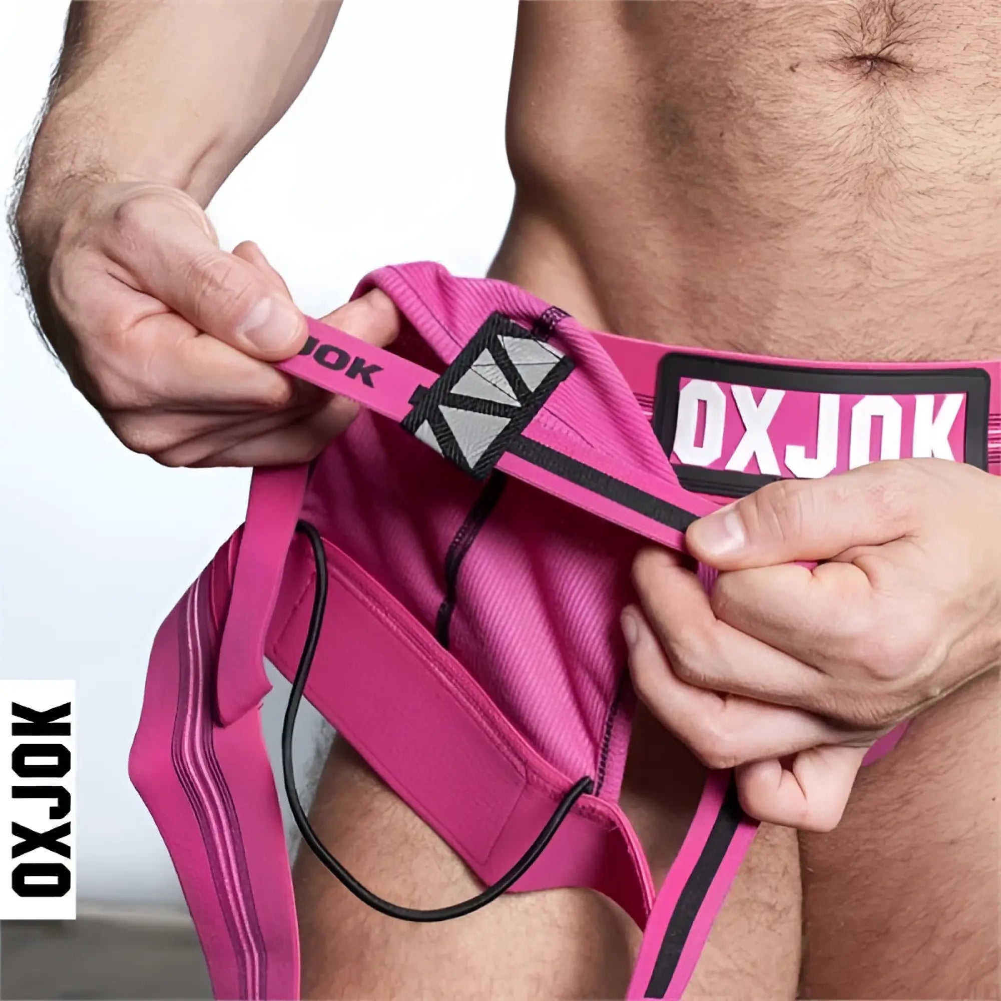 Bright pink oxjok slingjock jockstrap briefs with black trim and a geometric pattern waistband for support