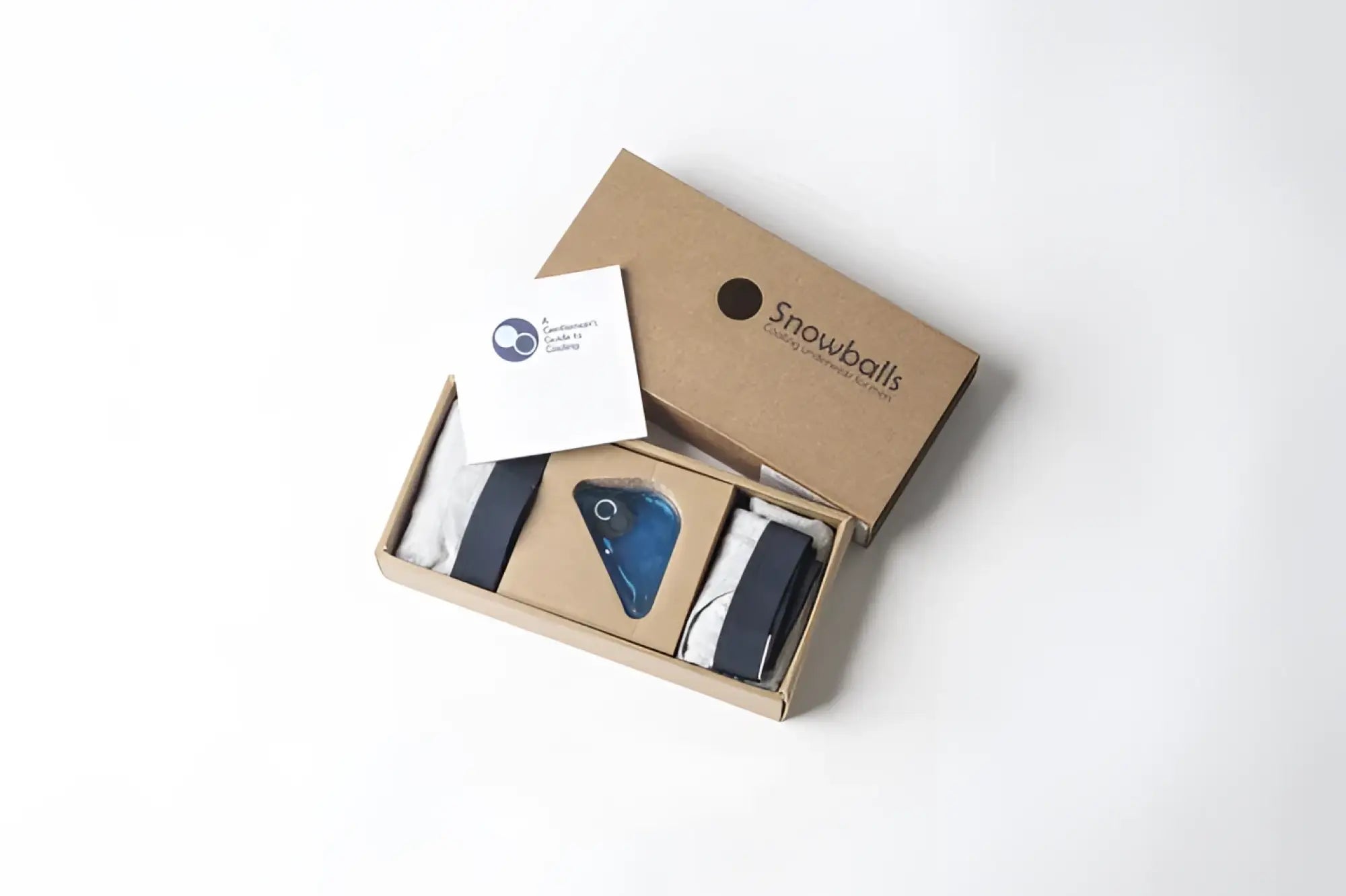 A sleek minimalist brown cardboard box of snowballs underwear with brand name and logo on the lid