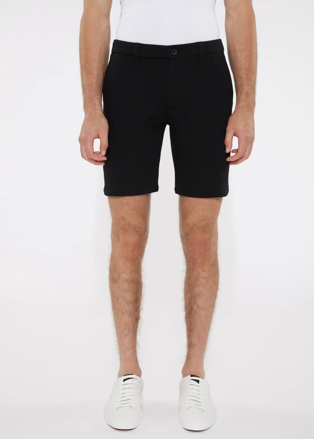 Black tailored chino shorts in solid stretch knit with sleek modern cut and subtle stitching details