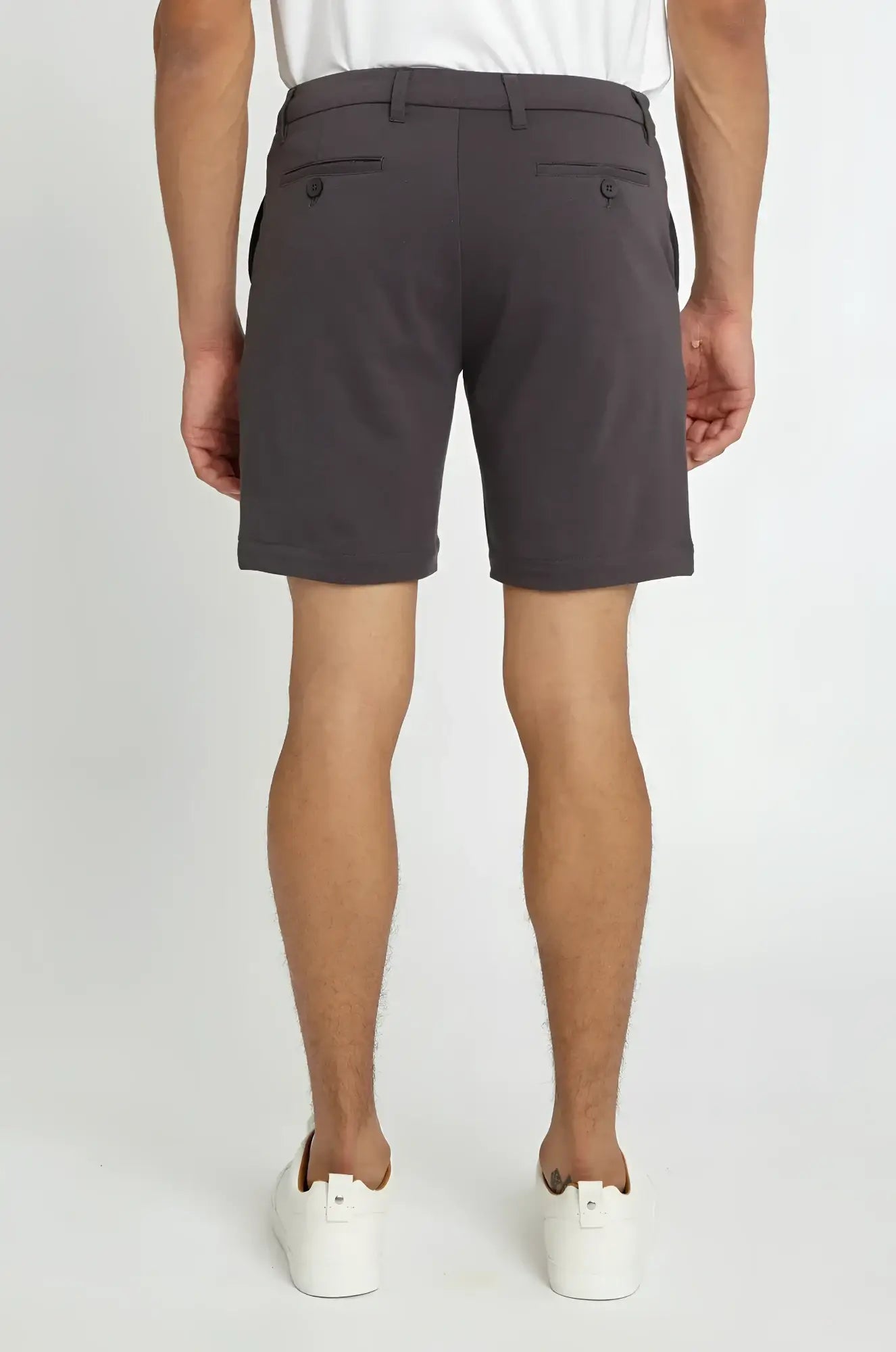 Dark gray solid stretch knit shorts with tailored fit and buttoned back pockets shown from the back side