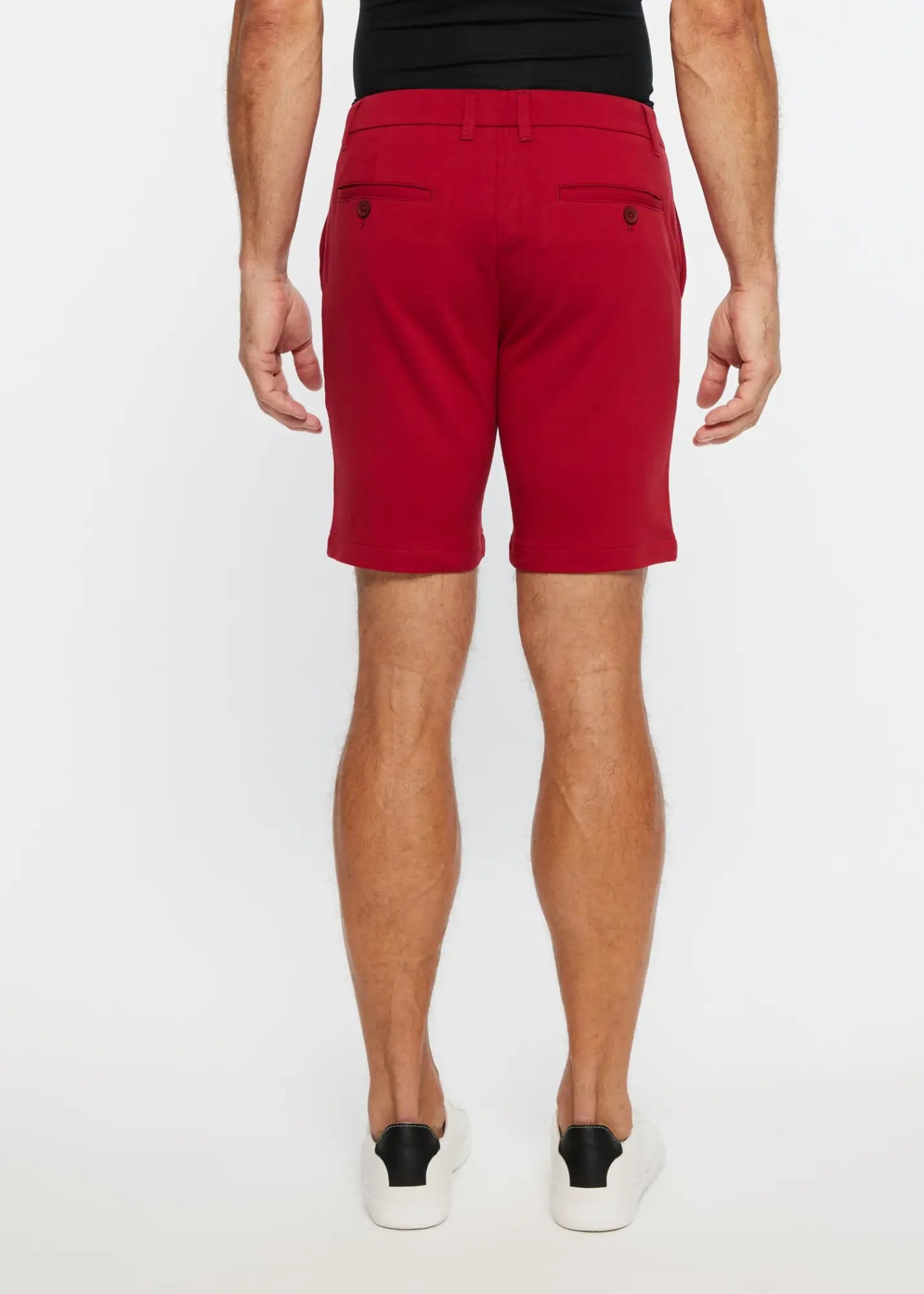 Red men’s solid stretch knit chino shorts with tailored fit and buttoned back pockets showing the back side