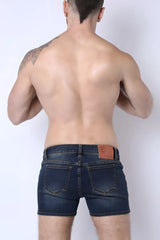 Back side of soma 2.0 denim booty short in dark blue with brown leather patch on waistband made of denim material