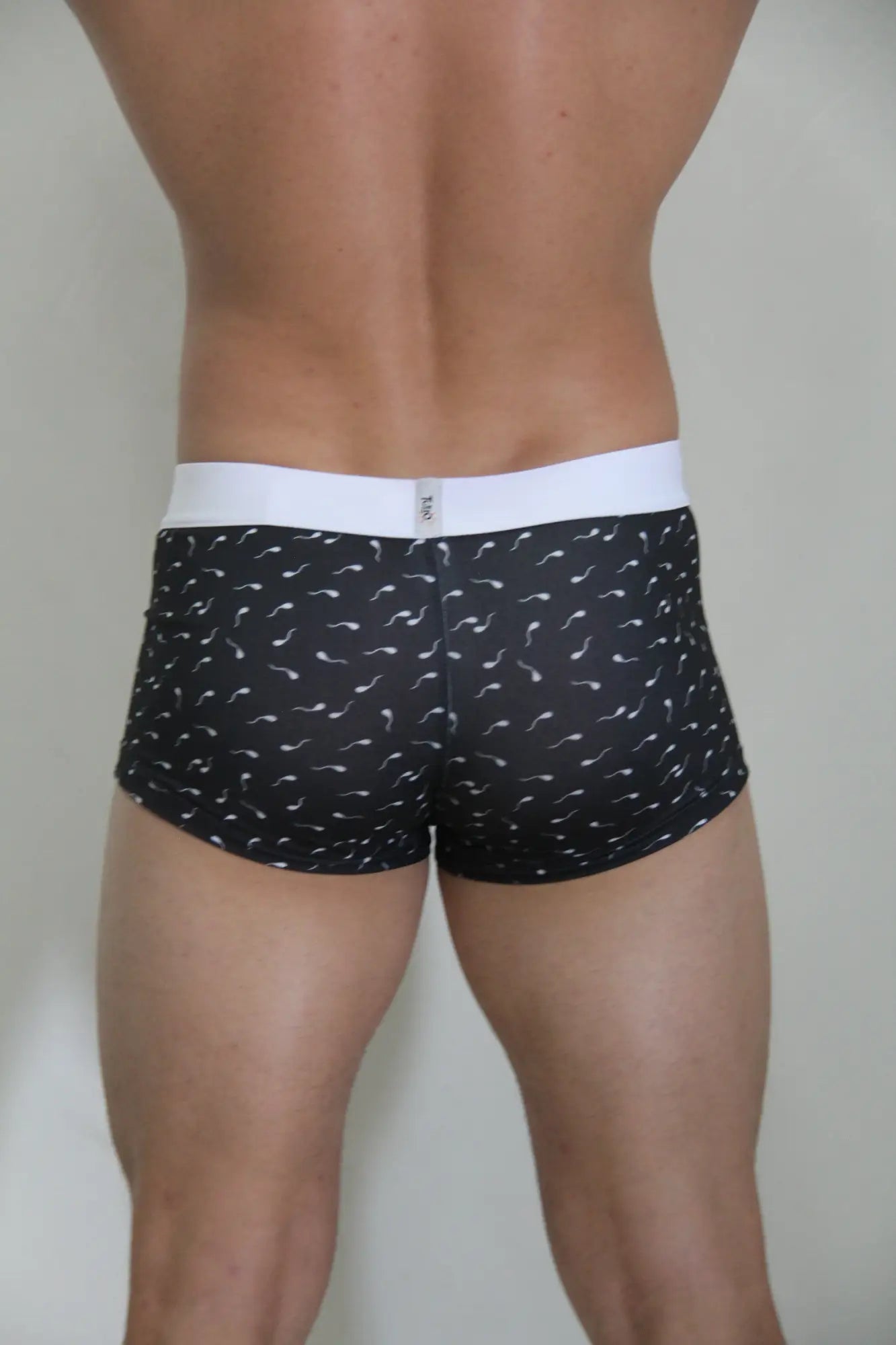 Black sperm trunk boxer briefs with white waistband and white stylized sperm cell pattern for everyday comfort