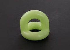 A smooth light green silicone sport f-cker tpr c ring glow with a glossy finish and open center size one size