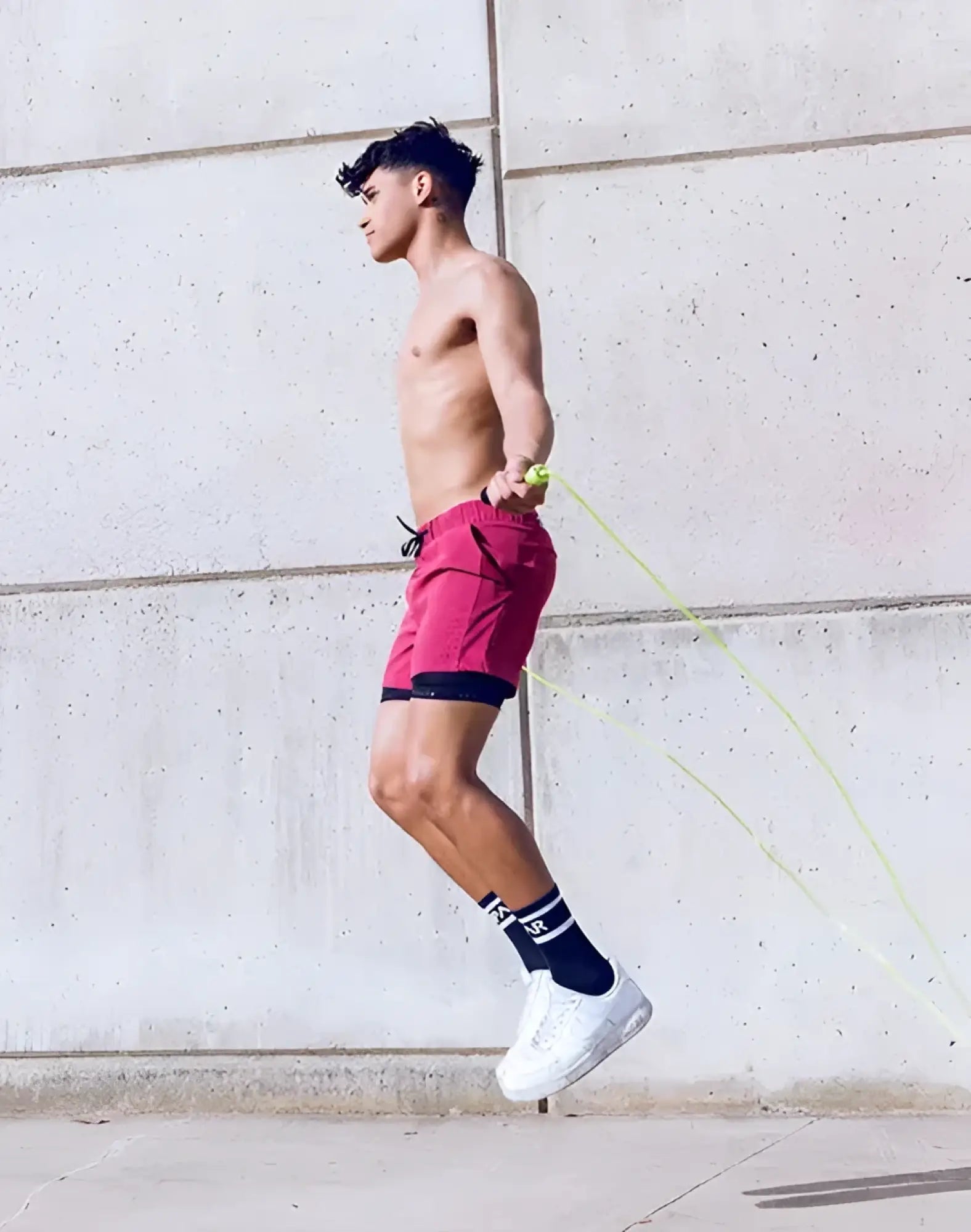 A vibrant red spr max short with black trim and drawstring waistband designed for athletic performance
