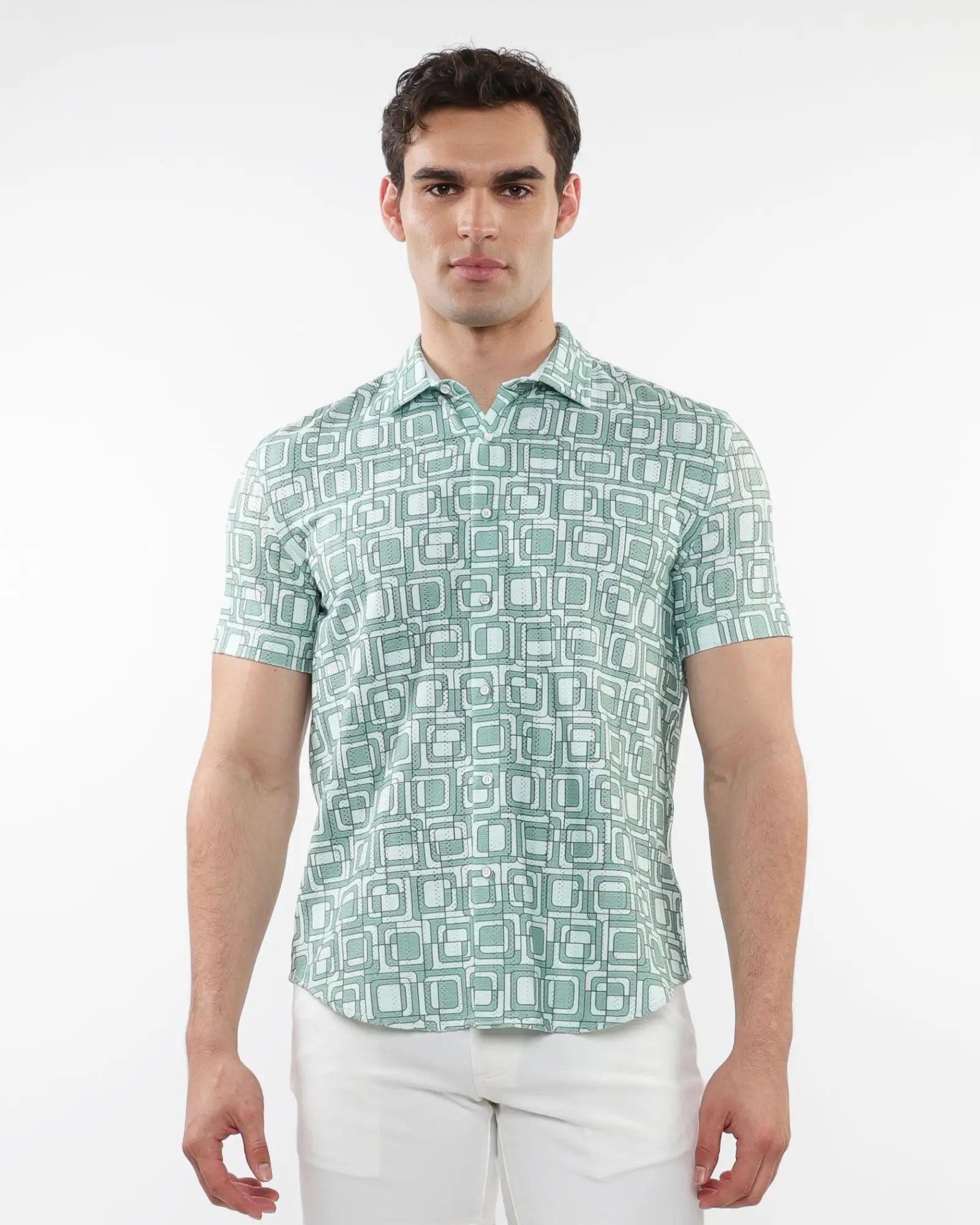 A man wearing a light green and white squares print open knit short-sleeve polo shirt