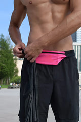 Bright pink ssbag runing belt waist pouch with black trim and adjustable strap worn around the midsection