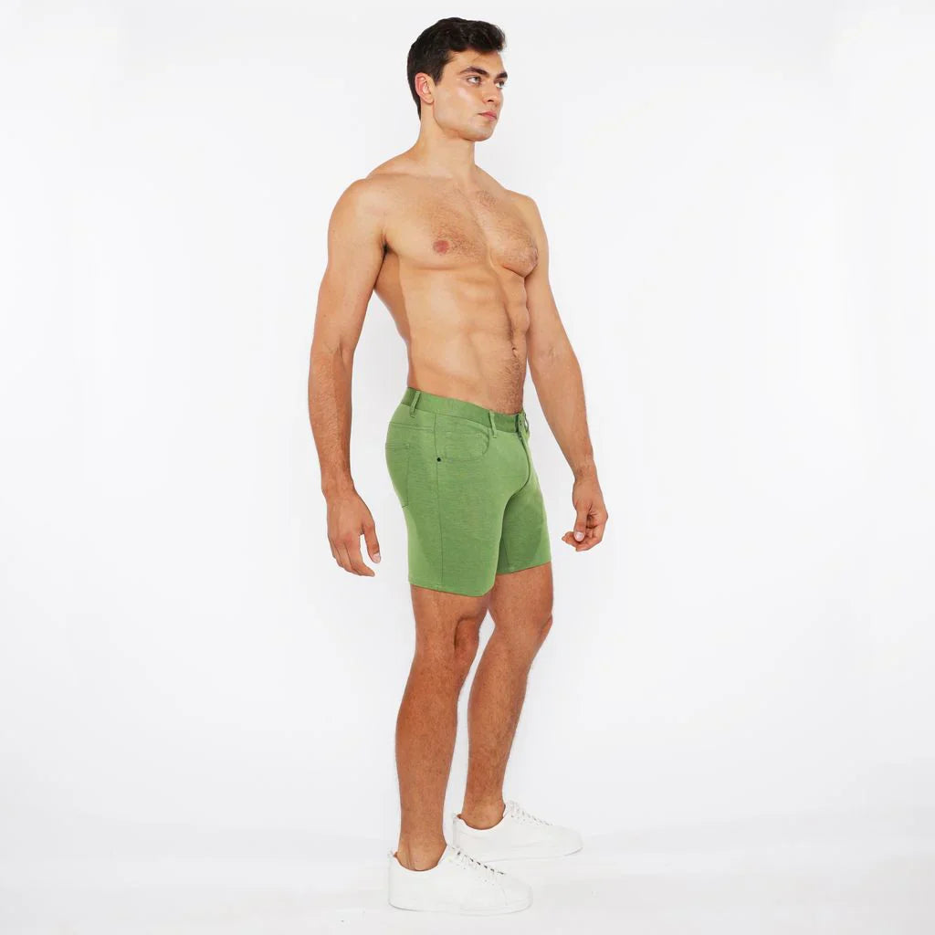 Green stretch knit short athletic shorts with fitted cut and visible stitching details for active wear