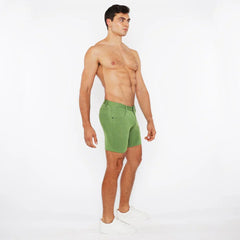 Green stretch knit short athletic shorts with fitted cut and visible stitching details for active wear
