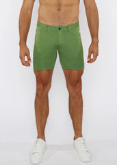 Green stretch knit shorts with subtle textured fabric and classic five-pocket design for comfortable wear