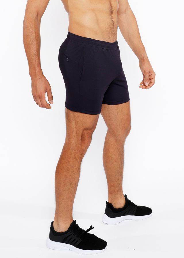 Black textured mesh stretch performance shorts with a sleek form fitting design and subtle side pockets