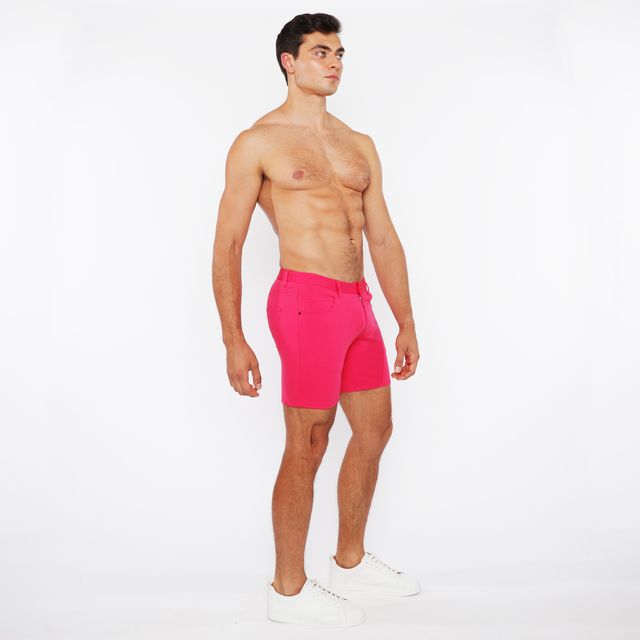 Bright pink stretch knit short with tailored fit and belt loops designed for athletic wear and comfort