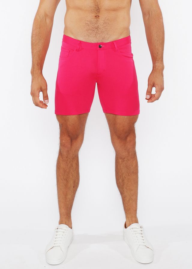 Bright pink stretch knit shorts for men with a clean tailored fit and single button closure