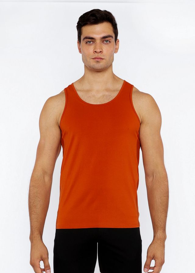 A solid orange stretch jersey tank top with circle spine laser cut detail and a simple round neckline