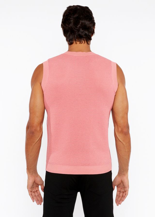 A pink ribbed knit sleeveless top with a crew neckline in a textured open knit vest design