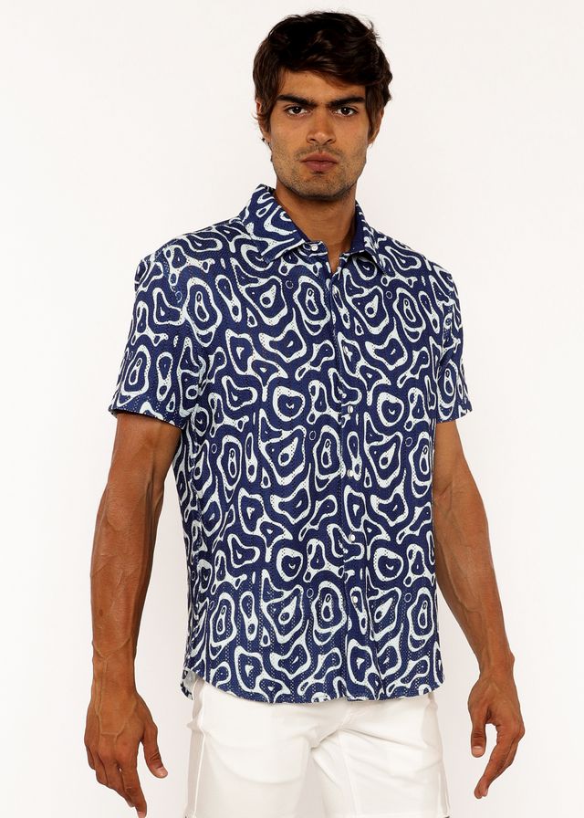 A navy blue squiggly print open knit short-sleeved button-up shirt with a white abstract pattern