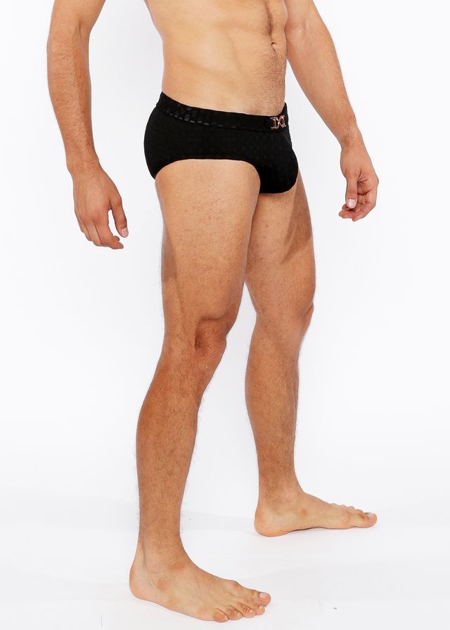 Black textured swim brief with front buckle and subtle pink logo on waistband designed for men