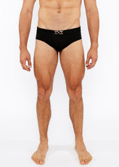 Black textured swim brief with a silver metallic interlocking double-x front buckle belt for stylish beachwear