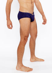 Navy blue textured swim brief with front buckle and metallic logo on waistband designed for stylish swimming