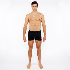 Black pinstripe swim short briefs featuring a single white button at the waistband for stylish beachwear