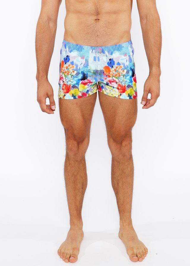 Vibrant multicolored floral abstract printed swim shorts with lively castle print in blue red yellow and orange