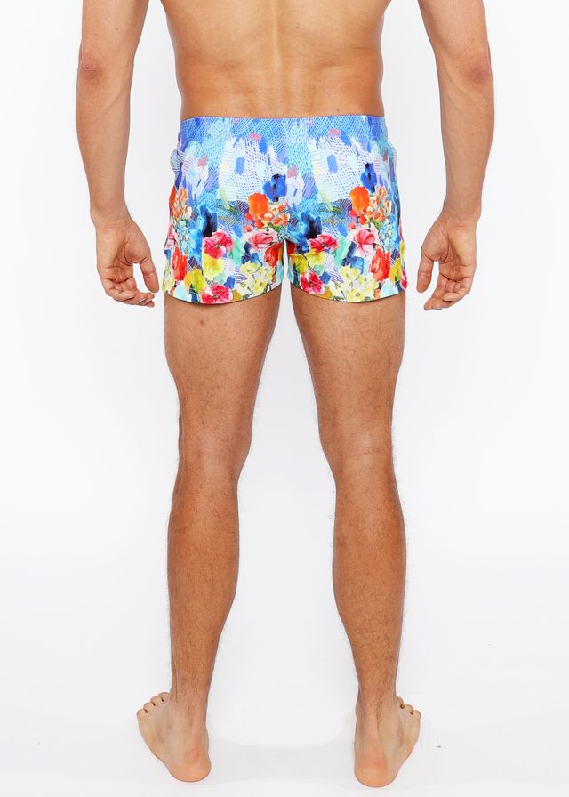 Floral abstract printed swim short featuring vibrant blue orange red and yellow floral pattern for beachwear