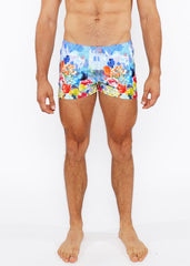 Vibrant multicolored floral abstract printed swim shorts with lively castle print in blue red yellow and orange