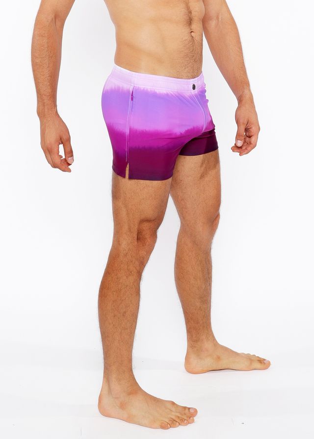 Purple gradient printed swim shorts with white to purple tie dye pattern and side slit for casual beachwear