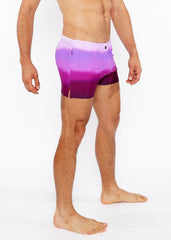 Purple gradient printed swim shorts with white to purple tie dye pattern and side slit for casual beachwear