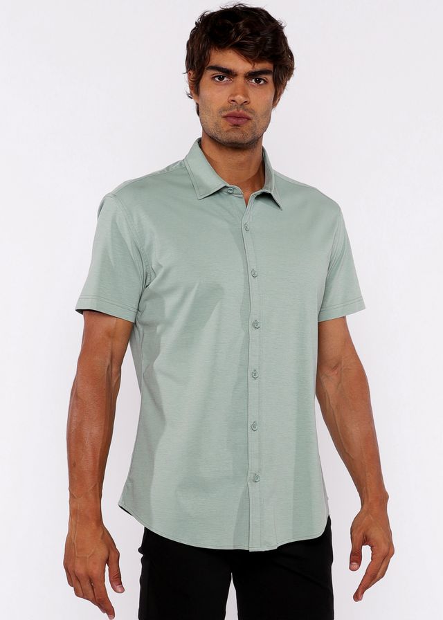 A man wearing a light green stretch knit shirt with short sleeves and a classic collar in neatly pressed fabric