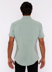 A light green stretch knit shirt for men with short sleeves and tailored fit featuring subtle stitching details