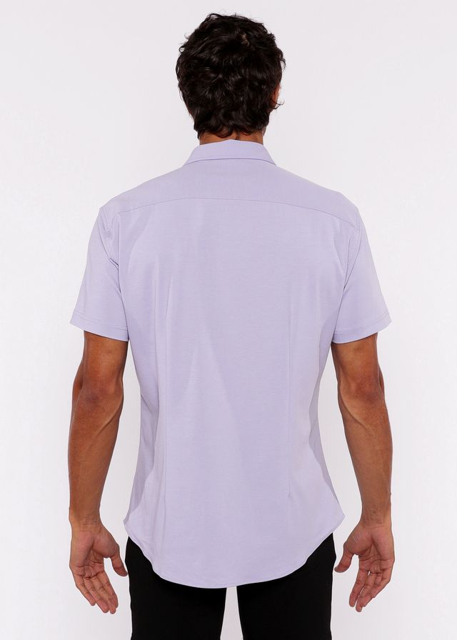 A man wearing a lavender stretch knit short-sleeved shirt with a classic collar and tailored fit