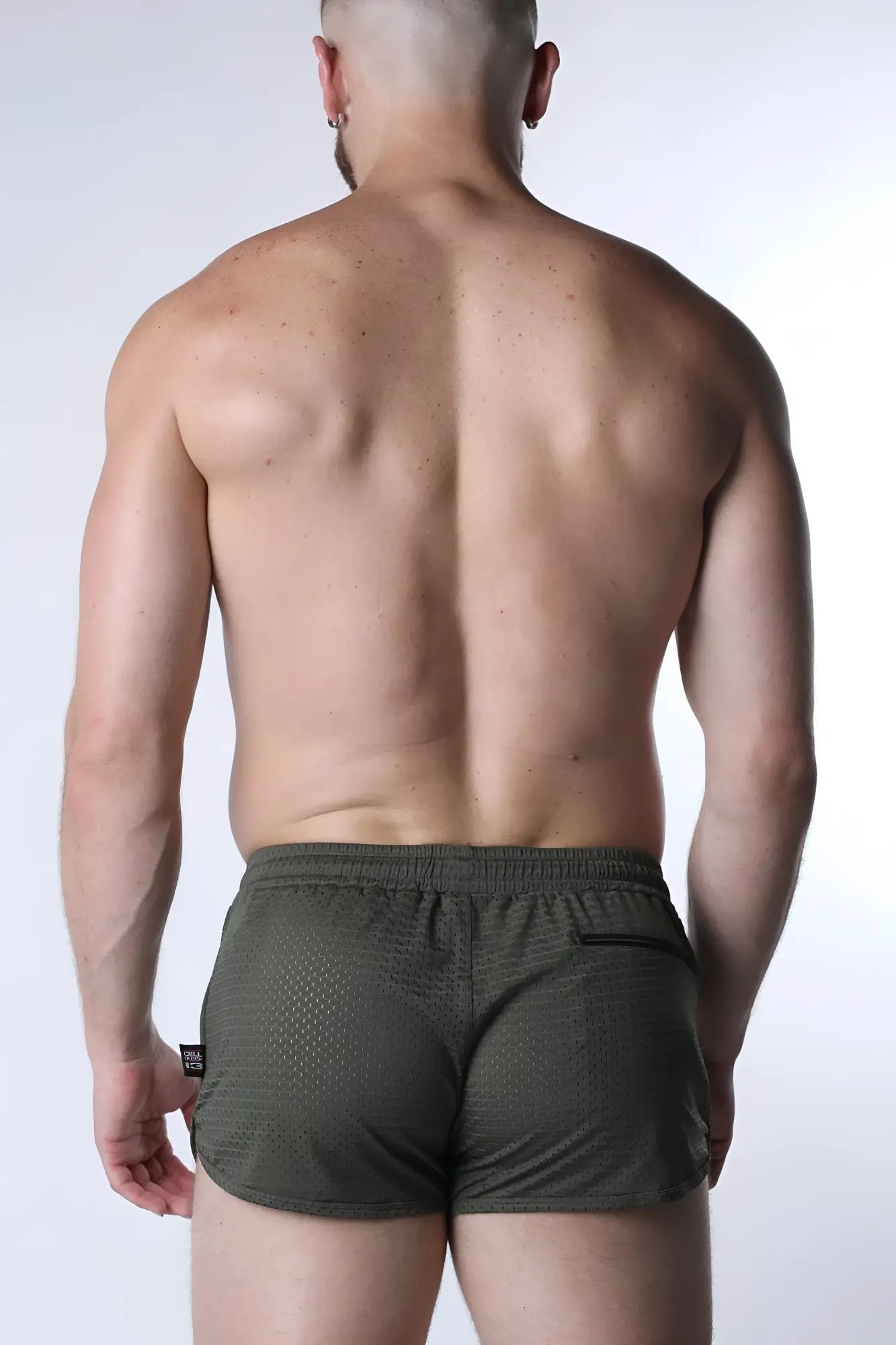 Olive green starter mesh shorts with textured fabric and black side pocket for athletic use