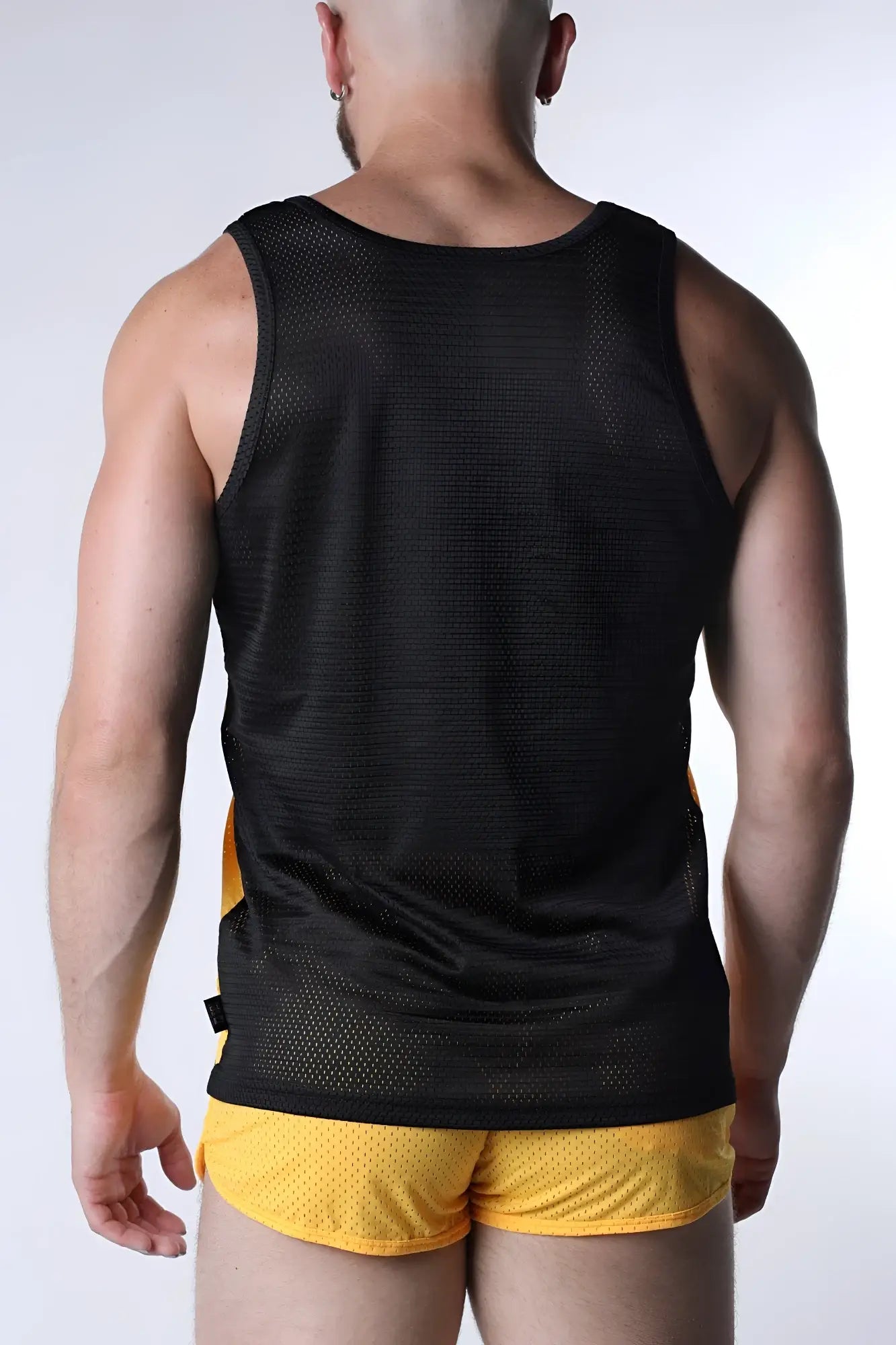 Starter mesh tank top in black with yellow side panels featuring breathable mesh fabric for athletic use