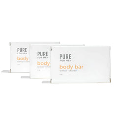 Three white rectangular boxes of pure for men lavender charcoal body bar labeled stay ready bar in orange and gray text