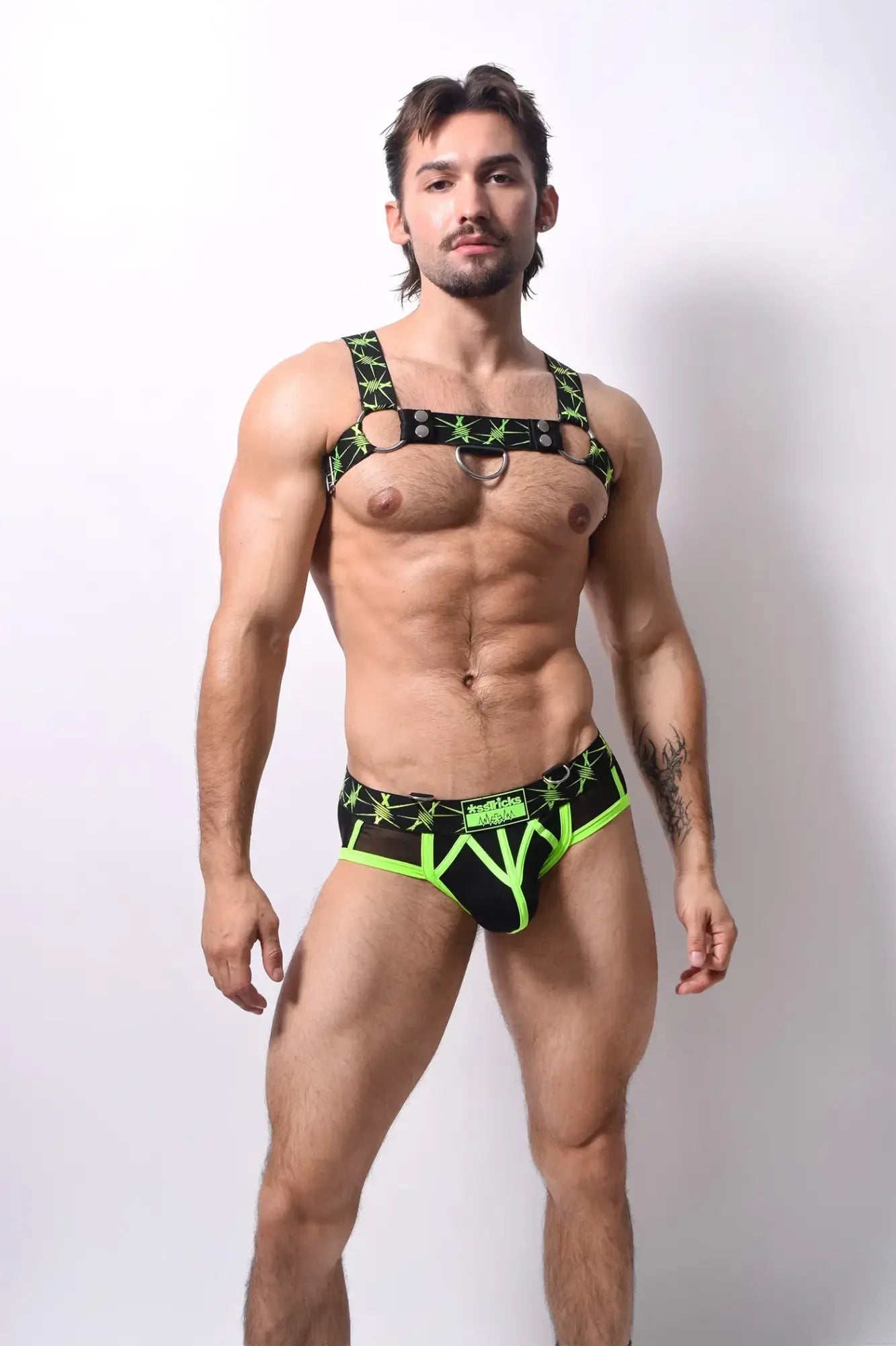 Black and neon green star patterned harness style briefs with bold edgy design stinger harness product image
