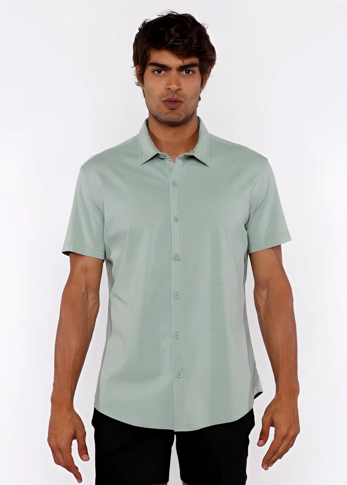 A light green stretch knit shirt with short sleeves classic collar and neatly stitched seams