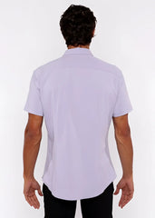 A man wearing a lavender stretch knit short-sleeved shirt with a classic collar and tailored fit